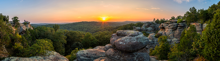 Valley and sunset of boulders and bushy trees
