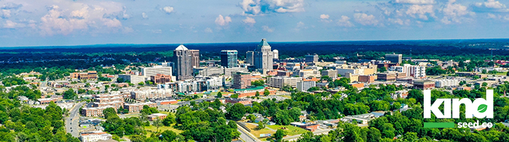 NC city scape with Kind Seed Co logo