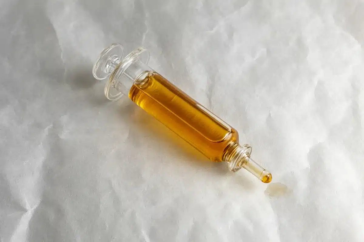 Amber cannabis oil in a glass syringe