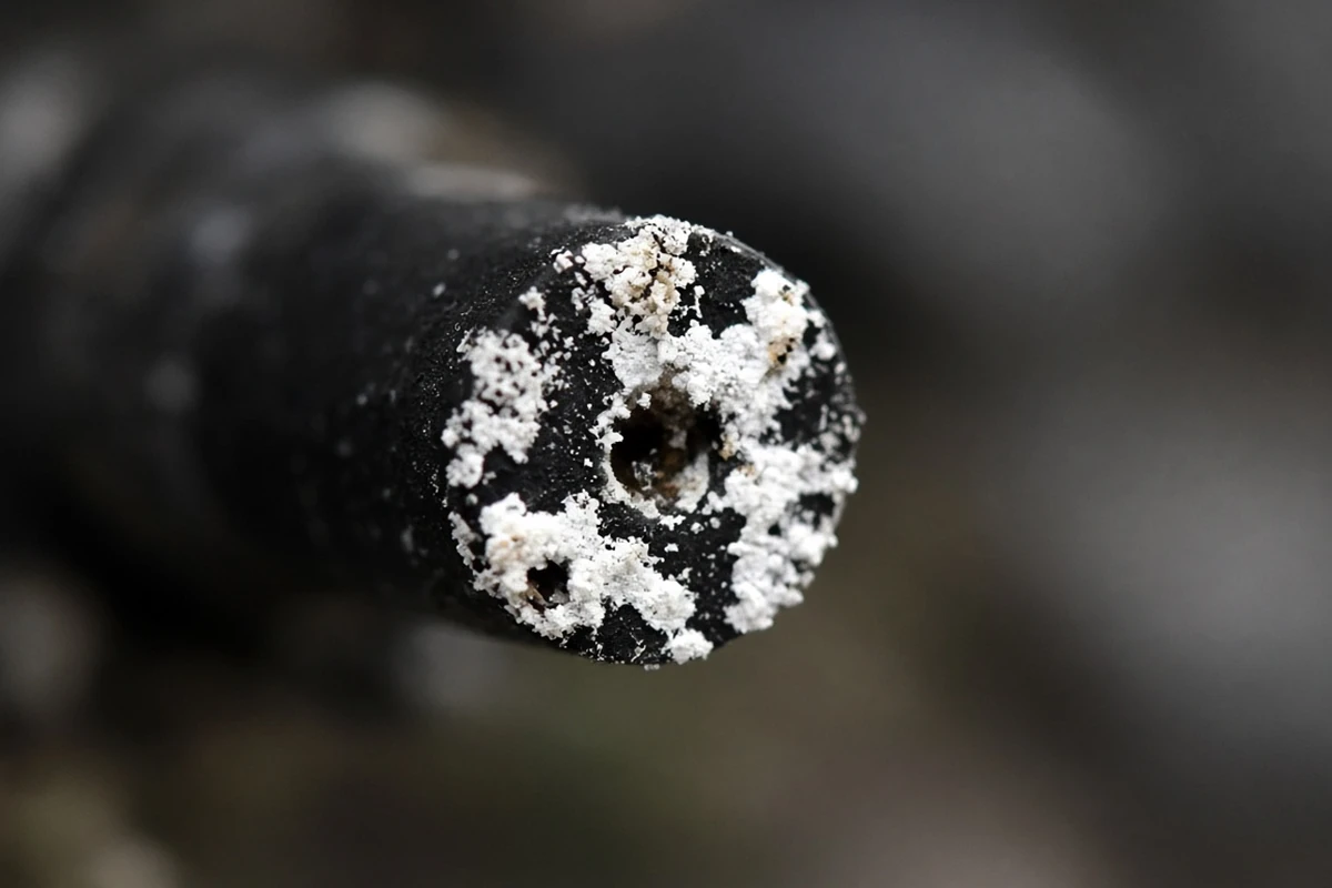 Close view of a crusted drip emitter tip