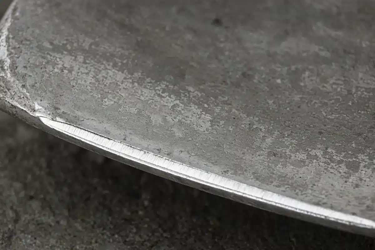 Shovel edge showing a clean line of freshly filed steel